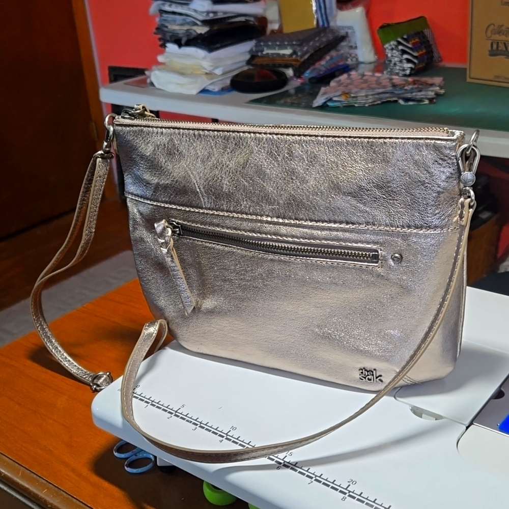 The Sak, silver crossbody bag, 11.5x9x2.  Used once for a wedding.